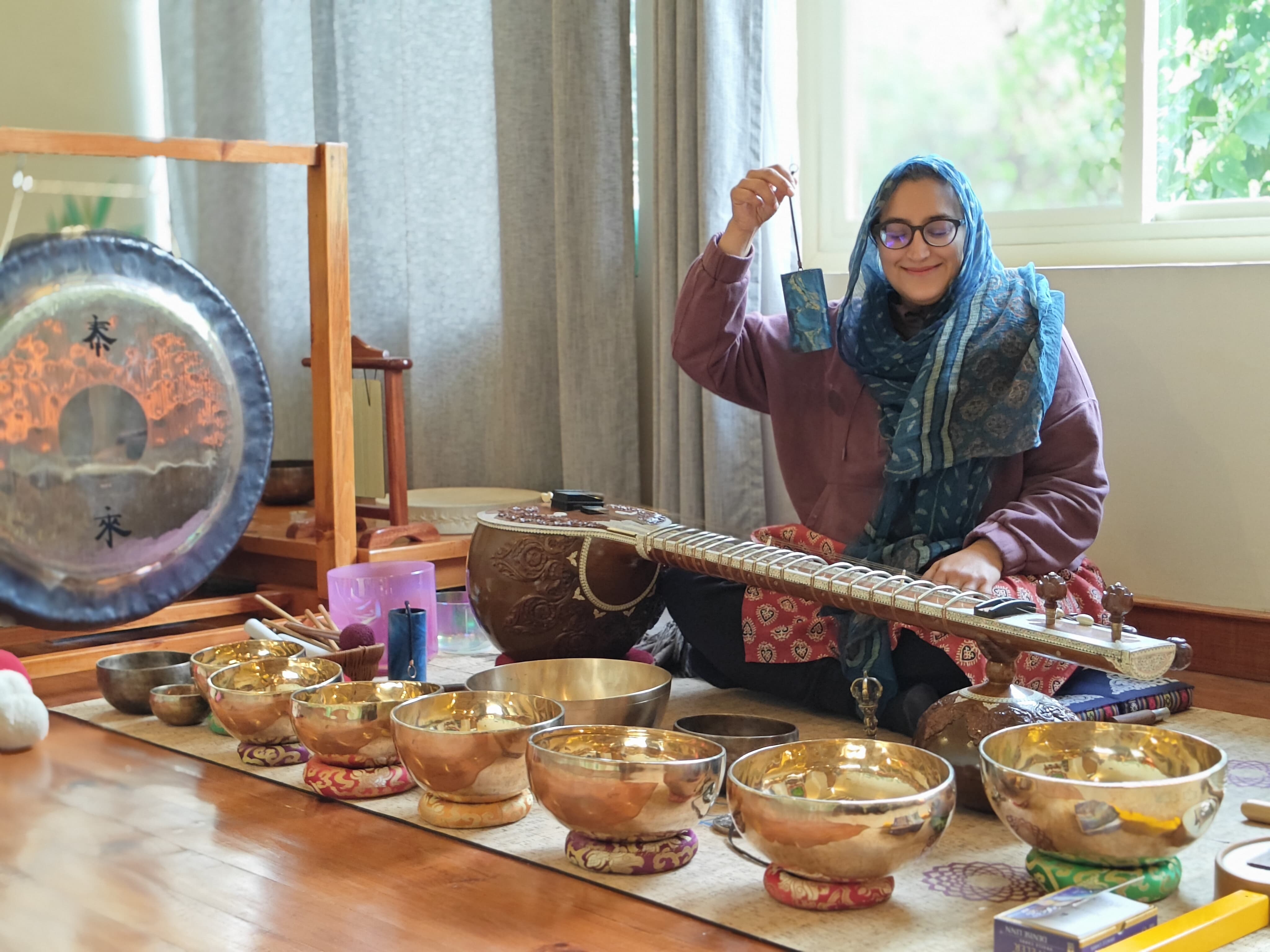 Sound-healing practice with singing bowls, a gong and other instruments