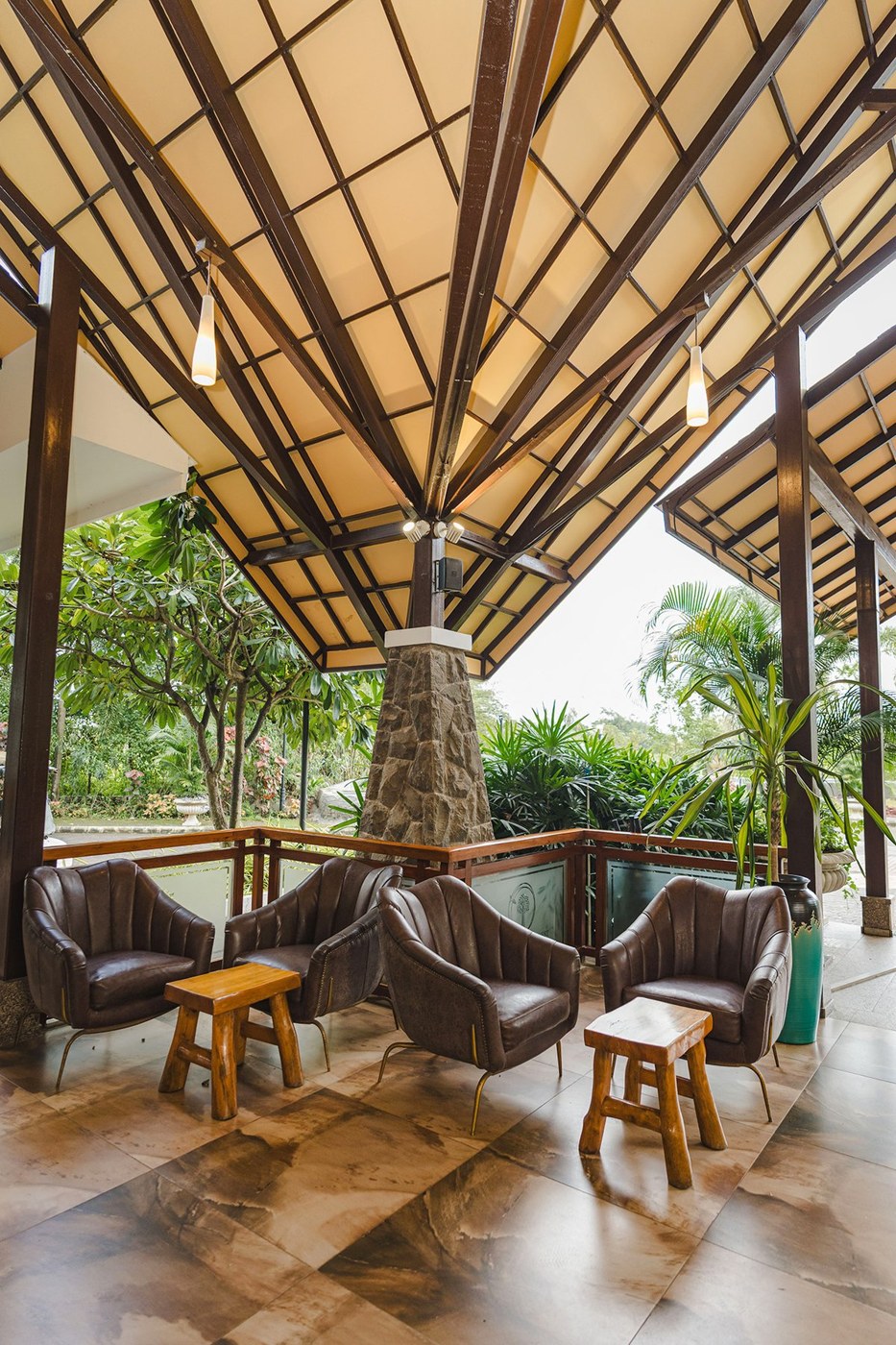An open-air lounge surrounded by greenery at Fazlani Nature’s Nest